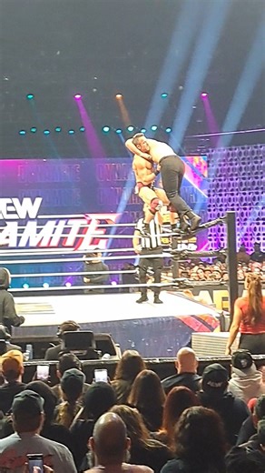 Roderick Strong hitting a Top Rope Suplex on Jon Moxley