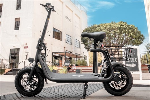 You don't even have to stand to zoom around town with this e-scooter