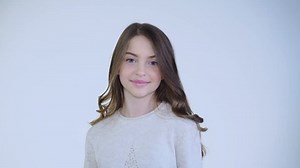 Pretty young girl smiling and posing at camera on white background. Full HD