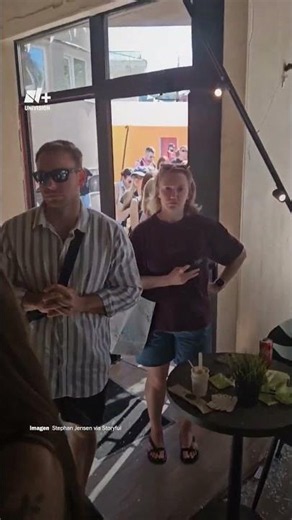 They line up to support a cafe damaged in a Russian attack