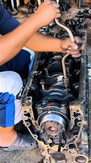 An expert mechanic assembles an engine block perfectly.