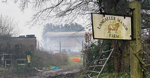 Pictures show barn smouldering more than 12 hours later