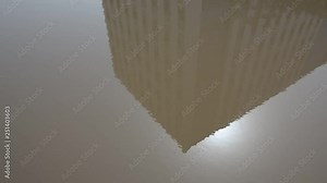 reflection of building in a mud puddle