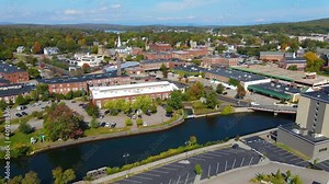 Laconia city center and Opechee Bay of Lake Winnipesaukee aerial view with fall foliage in downtown Laconia, New Hampshire NH, USA.