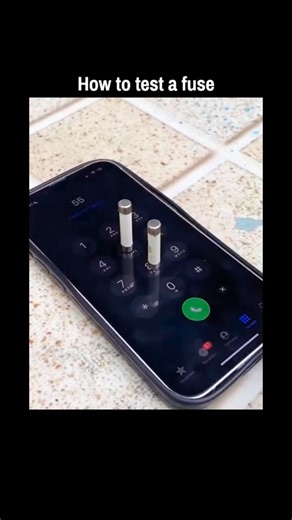 Universal View on Instagram: "shares a short video parodying fuse testing by balancing tiny electrical fuses on a smartphone’s dial pad keys, mimicking a call to absurdly “activate” them, which draws laughs for its blatant impracticality. Released on 30 December 2025, the clip has exploded to 259,000 views and 460 likes, with replies in Indonesian and English playfully debunking the method, highlighting its chaotic humour that fits the author’s self-described “sometimes serious, sometimes chaoti