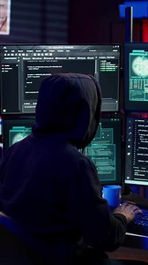 Vertical Hacker happy after successfully doing computer sabotage using ransomware, seeing access granted message. Cybercriminal successfully gaining access to victim data, demanding ransom money, camera B
