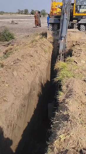 Volvo Excavator Digging a Trench at Construction Site
