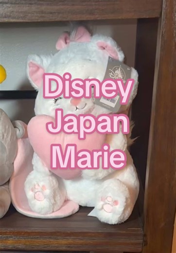 Disney Store Marie with Heart plush from The Aristocats, officially licensed Disney Store Japan exclusive featuring Marie holding a soft pastel pink heart. This elegant 13¾-inch plush captures Marie’s sweet personality with her signature bow, embroidered lashes, soft white fur, and charming heart detail that adds a romantic, collectible touch. Designed with ultra-soft materials and delicate pastel accents, this Marie plush is both cuddly and display-worthy. Her gentle expression and classic Disn