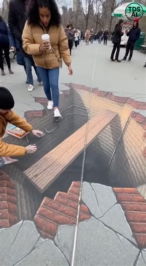 Pedestrian steps onto 3D sidewalk art and unexpectedly drops from view CHICAGO, ILLINOIS — Street-level footage captured a surprising moment when a pedestrian walking across a realistic 3D chalk drawing appeared to fall through what looked like a painted illusion on the sidewalk. The video shows a detailed artwork designed to resemble a deep opening in the pavement, complete with shadowing and perspective effects. As passersby gather to take photos, one individual confidently steps onto the imag
