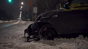 Aftermath of mva motor vehicle accident on snowy winter night with traffic light and street lights in background in urban setting Premium Stock Video Footage