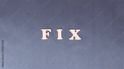 Problem Solving Concept 'Fix' Spelling in Wooden Alphabet Letters on Chart Paper and Arranged by Hand