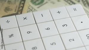 Calculator buttons rotate, macro. Bank operation, investment. Credit concept. Banknotes english pound, dollar, euro, close up. Calculate costs using calculator