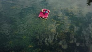 Cute couple enjoying a boat ride in the park.