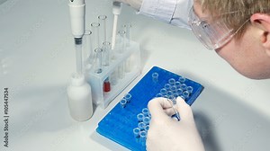 Lab technician scientist performs medical clinic chemical analysis and diagnostics using test tube phial and pipette. 4K UHD video footage.