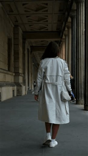 clip-4004062587-berlin-germany-woman-walking-historic-colonnade-columns