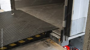 Loading ramp dock leveler adjusting height for cargo to be loaded on trailer