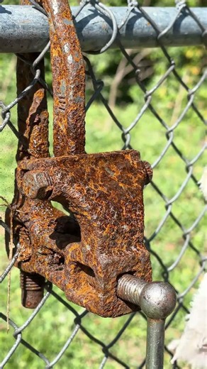 Spray Cleaning One Spot on a Rusty Fence Clamp