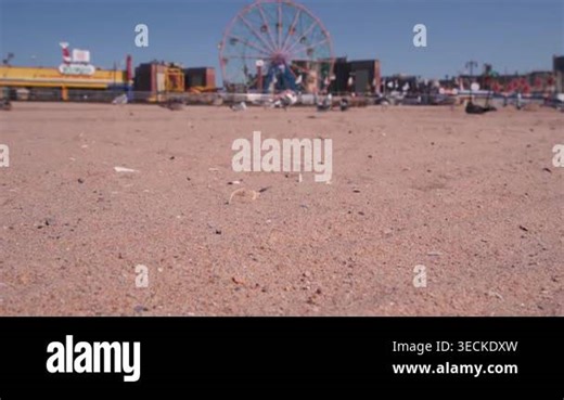 Coney Island sandy beach in Brooklyn, New York, United States. Boardwalk near retro luna park. Ferris wheel in american amusement park on ocean coast. Waterfront summer holiday promenade in NYC, USA Stock Video Footage - Alamy