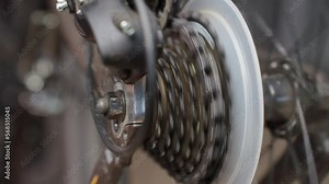 Process of shifting gears on rear transmission of bicycle. Bicycle gear drivetrain and cassete, close up. Maintenance bike transmition