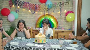 Celebrating a child's 10th birthday with friends in a vibrant indoor party filled with decorations, fun, and joyful moments