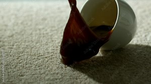Cup of coffee falling and spilling over carpet Stock Video