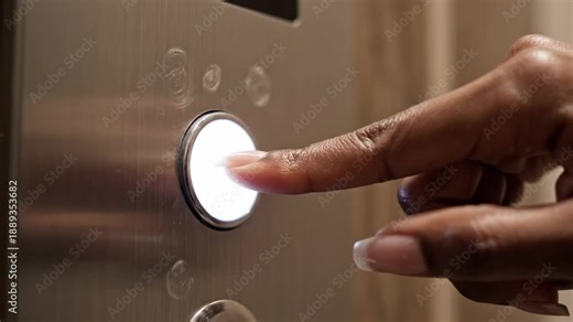 Hands pressing elevator button. Close-up of hands pressing an elevator button, capturing the tactile interaction and slight reflection on the panel.