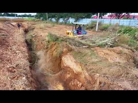 WONDERFUL.OPERATED OF FILLING FLOODED LAND NEXT TO THE ROADS USE SHANTUI DOZER AND SMALL DUMP TRUCKS