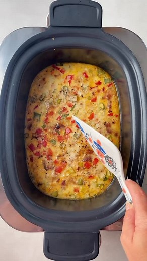 This easy slow cooker breakfast casserole recipe with bacon, cheese,...