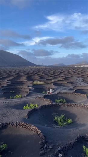 Lanzarote on Instagram: "🌟 Follow @lanzarote_official for breathtaking views and travel inspiration! 📸 Lanzarote is the ultimate destination to visit in 2024! 🌴✨ With its movie-like landscapes and sunny weather year-round, it’s a true Spanish gem. 🌞 ✍🏼 Must-see highlights: Volcán El Cuervo: Explore this iconic volcano and its unique lava formations. Bomba Volcánica Gigante: Marvel at the massive volcanic bomb and its impressive size. La Geria: Discover the picturesque vineyards set in volca