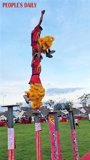 Performers of Xing Shi (awakening lion), a southern style of lion dance in China, showcase strength, agility, and a good sense of balance as they move across the poles during a warm-up in south China's Guangdong Province. | People's Daily, China