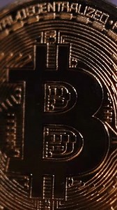 Bitcoin BTC coin and Ethereum ETH coins are rotating with 100 dollars bills. Digital crypto coin and cryptocurrency. Concept of exchange market and online trading. Trading in bull and bear markets