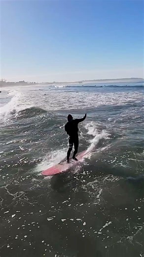 Red board on a good ride at Tourmaline Surf Park in San Diego 02/04/26