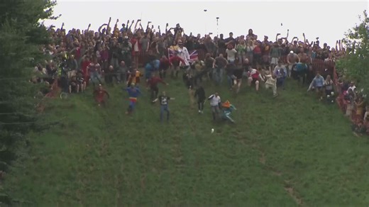 Thousands gather for annual cheese wheel chasing competition in England
