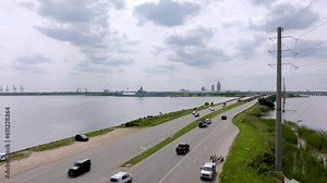 Wide view of freeway traffic on US 10 Battleship Parkway in Mobile, Alabama with drone video stable.