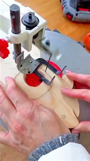 shaping a small piece of wood using a router table to create smooth curved edges on the inner part