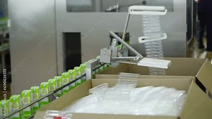 Production line at the Dairy Production Factory. Dairy Food is slowly moving on the production line. Small Green boxes with milk are exiting the production line for storing. Food Industry.