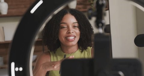 clip-4013267341-woman-starting-cell-recording-under-ringlight-vlog