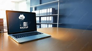 Laptop screen displaying the word BACKUP with a cloud storage icon, Focus on data backup and recovery, emphasizing secure cloud backup for disaster recovery