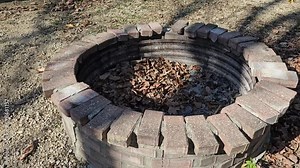 Fire pit outdoors made with bricks and metal Stock Video