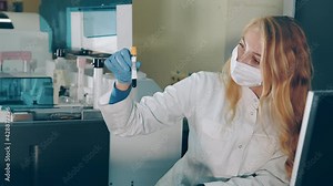 Blood test in the laboratory. The lab technician examines the blood tubes and checks the barcode and serial number of the biochemical tests in the laboratory. Developers of potential medicines and