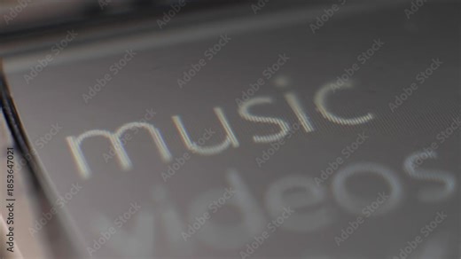 Macro view of vintage device menu scrolling through music, videos and pictures