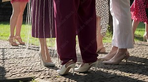 Women in evening dresses communicate at party, female legs in high heel shoes