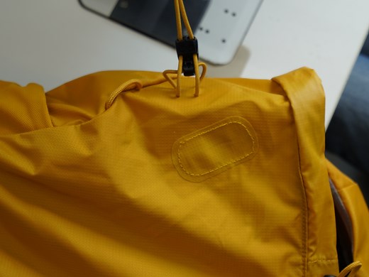 How can I mend holes or tears on my backpack?