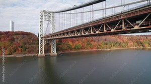 Rising aerial of New Jersey's gorgeous Palisades Park with George Washington Bridge and Hudson River in foreground