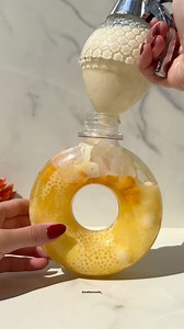 Have a SMILEY Monday ☀️😊 with 🥭🧋mango sago bowl in a donut shaped bottle Recipes • condensed milk yellow edible glitter • ice - coconut milk mango syrup & water • sago pearls mango syrup • frozen mango chunks • coconut jelly • mango syrup coconut milk #mangosago #creativedrink #homecafe #ice #iceasmr #mango #mangococonut #mangosyrup | Estherscafe