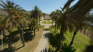 Drone passing Palos Verdes lighthouse and diving towards rocky California beach
