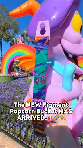 The NEW Figment Popcorn Bucket is HERE!!!! 🎨💜🌈🧑‍🎨 This version is a throwback to the OG Figment bucket that caused absolute chaos around EPCOT, but now he’s dressed and festive for Festival of the Arts with his bow, beret, and paint brush! 🎀🖌️🎨 �And good news…THE PAINT BRUSH LIGHTS UP! 💡 You can order him via the My Disney Experience app and pick him up at The Odyssey! Are YOU adding Artist Figgy to your popcorn bucket collection? ⬇️ | Disney Food Blog