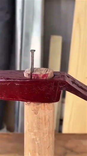 fixing hammer head to wooden handle by hammering nails and wooden wedges