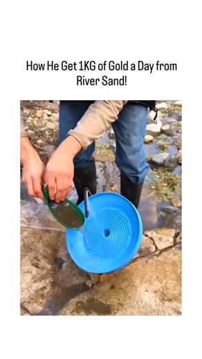 mr2m on Instagram: "The video depicts a man using a DIY blue spiral concentrator to pan river sand for gold flakes, followed by magnetic separation of black sands and torch-melting into a small nugget, but the visible yield is grams at most, not the claimed 1kg daily-equivalent to $80,000 at current prices. This post exemplifies viral , amassing millions of views through sensational titles, while replies overwhelmingly label it a scam tactic to hawk equipment, aligning with common YouTube/Tik To