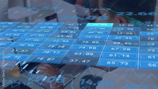 Analyst typing at laptop, updating transparent finance overlay with blue tiles, monitoring charts